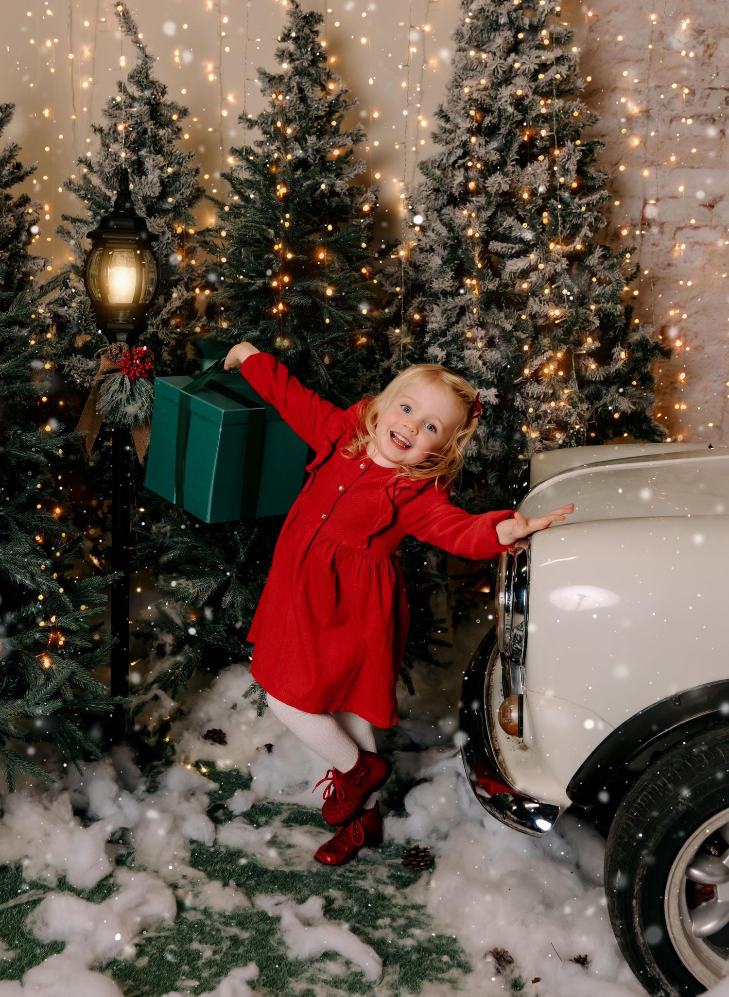 little girl dressed in red christmas dress with christmas presents. Christmas family photos Ireland