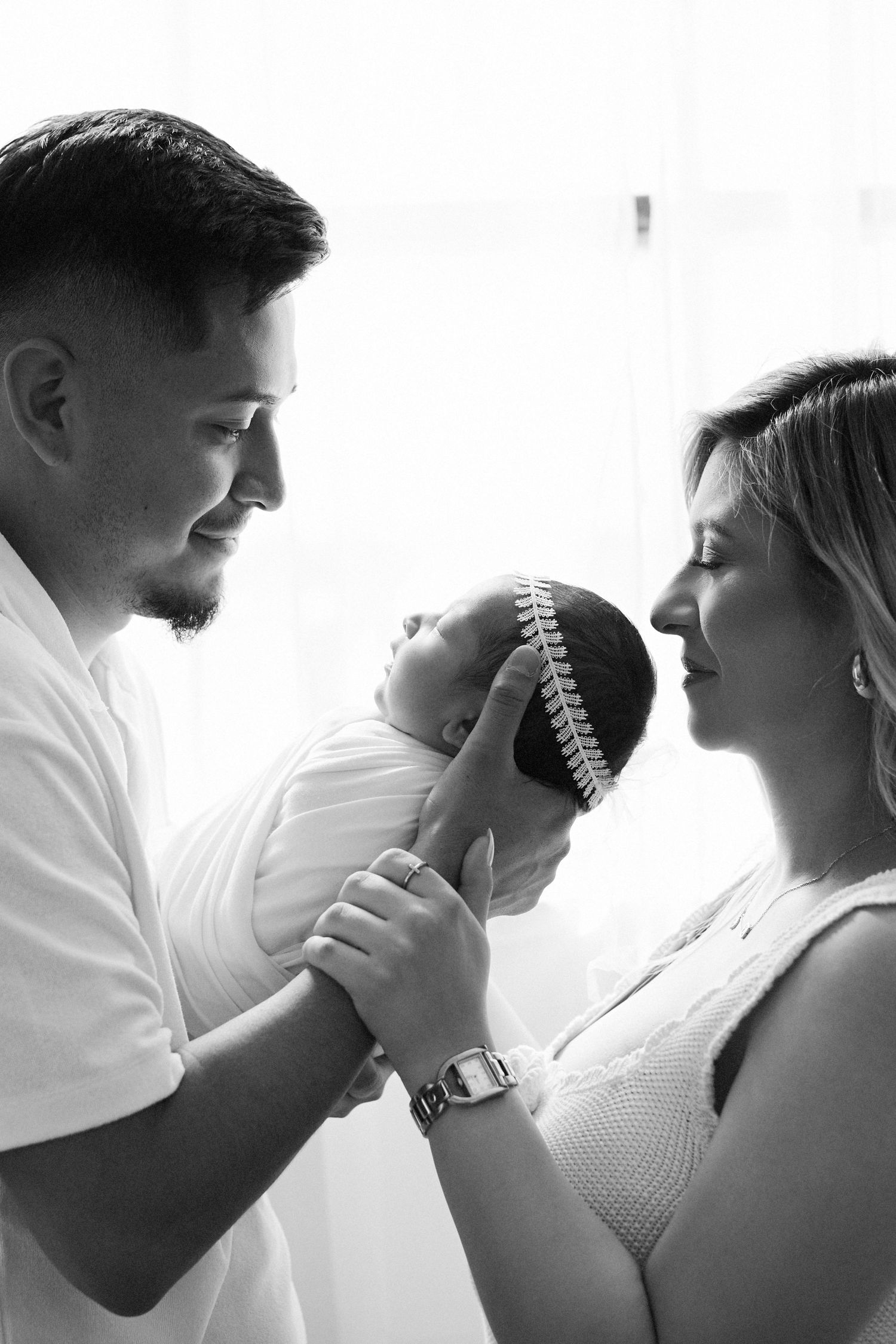 Intimate black and white close-up portraits of couple in romantic poses.