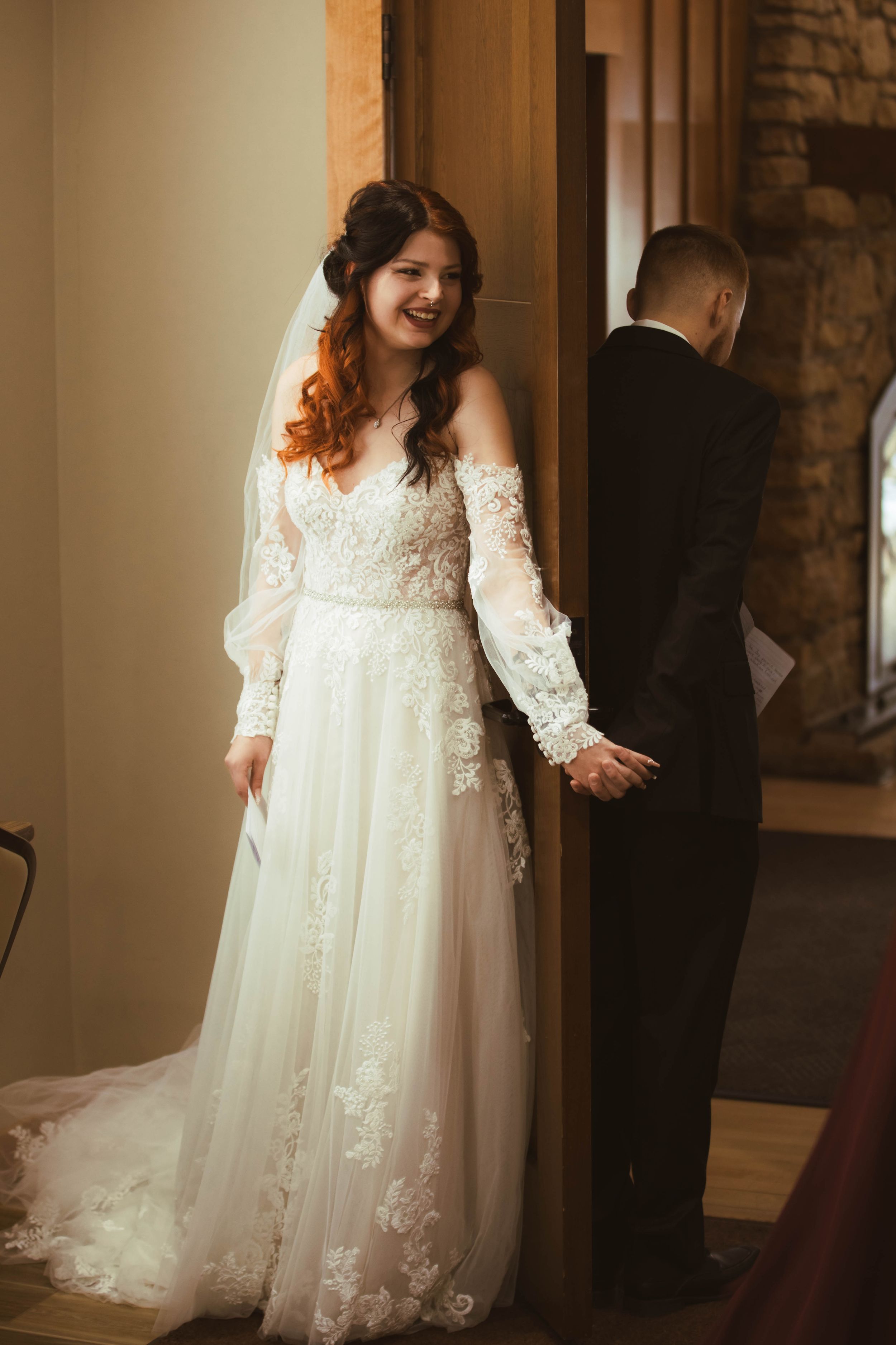 Intimate indoor wedding moments captured in warm lighting with vintage architectural details.