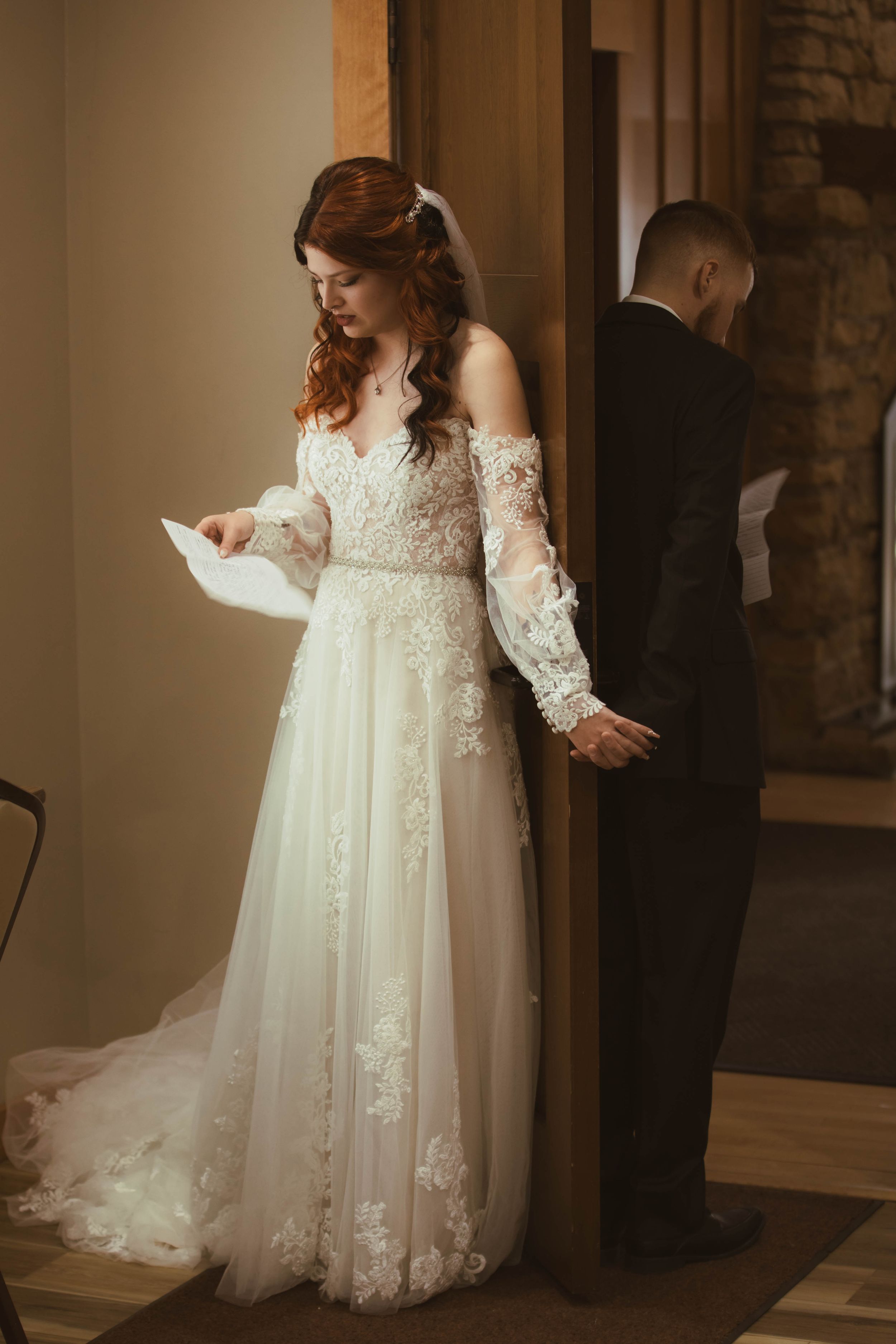 Elegant lace wedding gown with flowing train photographed in soft, natural light.
