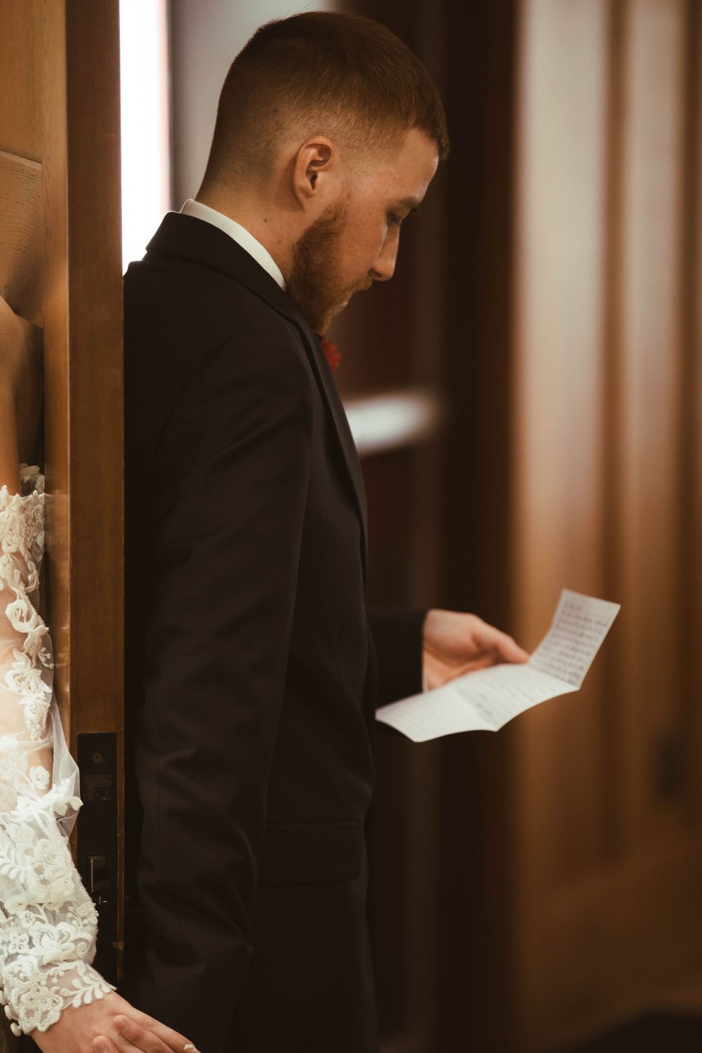 A couple reading letters to each other during a private moment before their wedding ceremony.