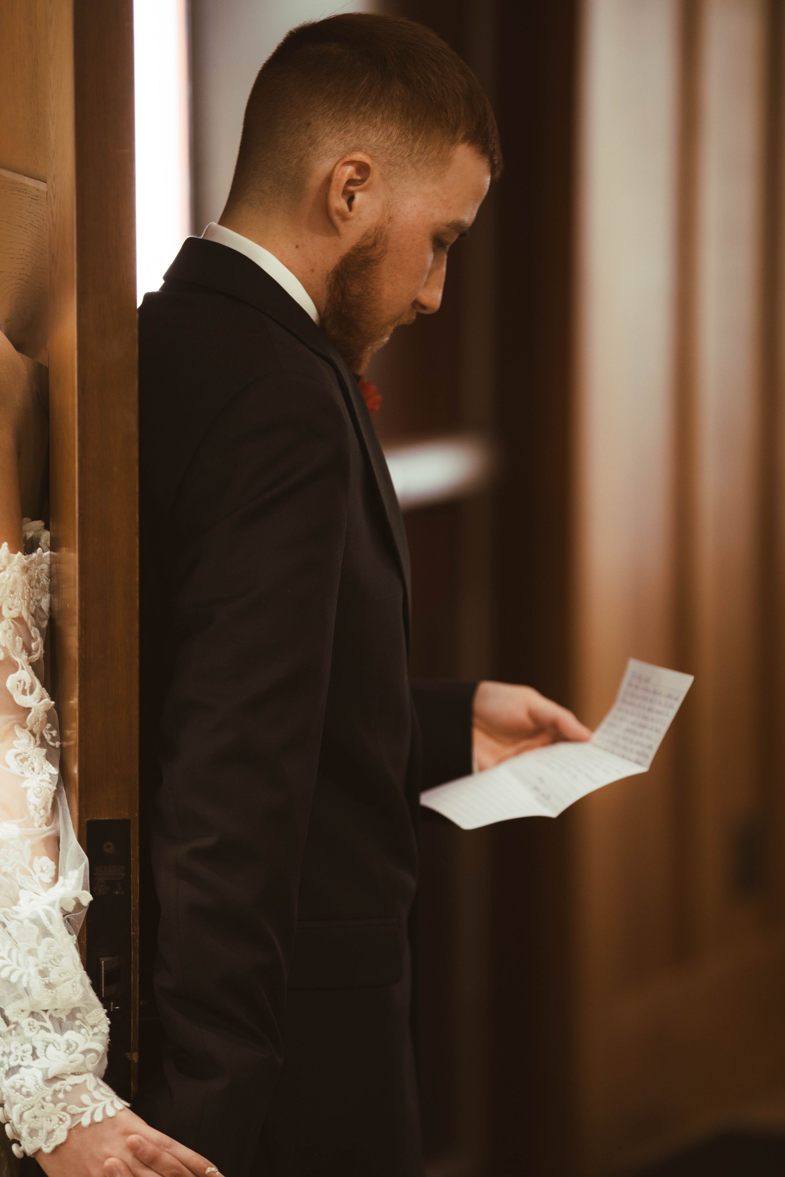 A couple reading letters to each other during a private moment before their wedding ceremony.