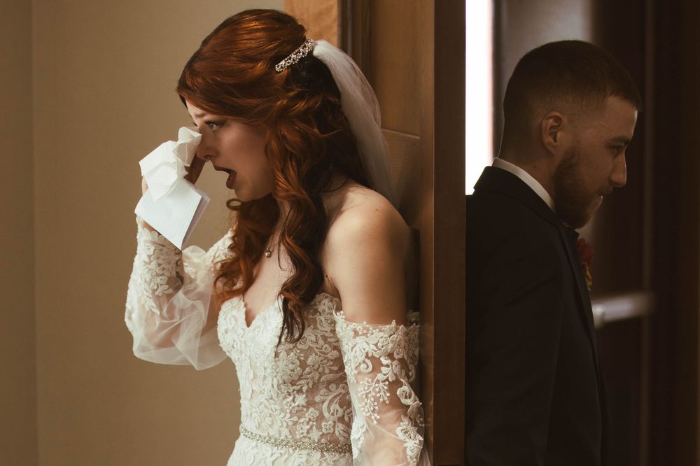 A romantic pre-wedding moment with a couple exchanging letters in a dimly lit hallway.