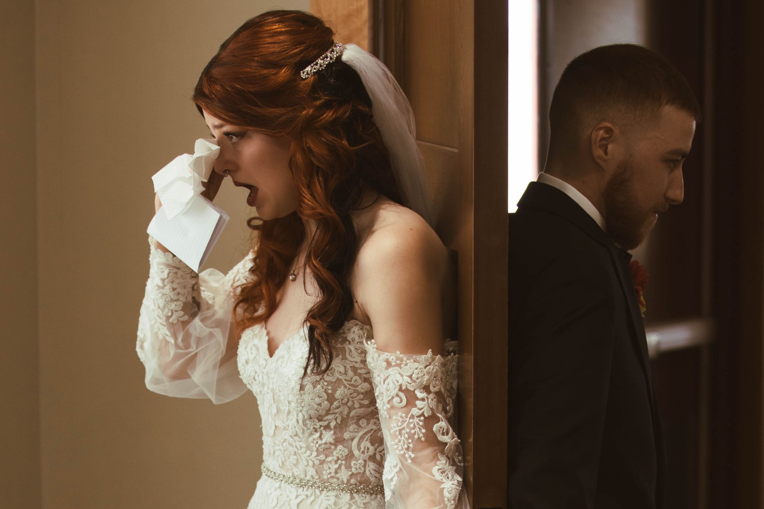 A romantic pre-wedding moment with a couple exchanging letters in a dimly lit hallway.