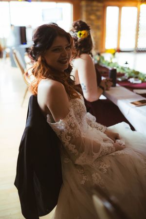 Intimate moment captured at a rustic wedding venue with soft natural lighting.