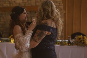 Wedding celebration in progress at a rustic venue with stone walls and wooden details.