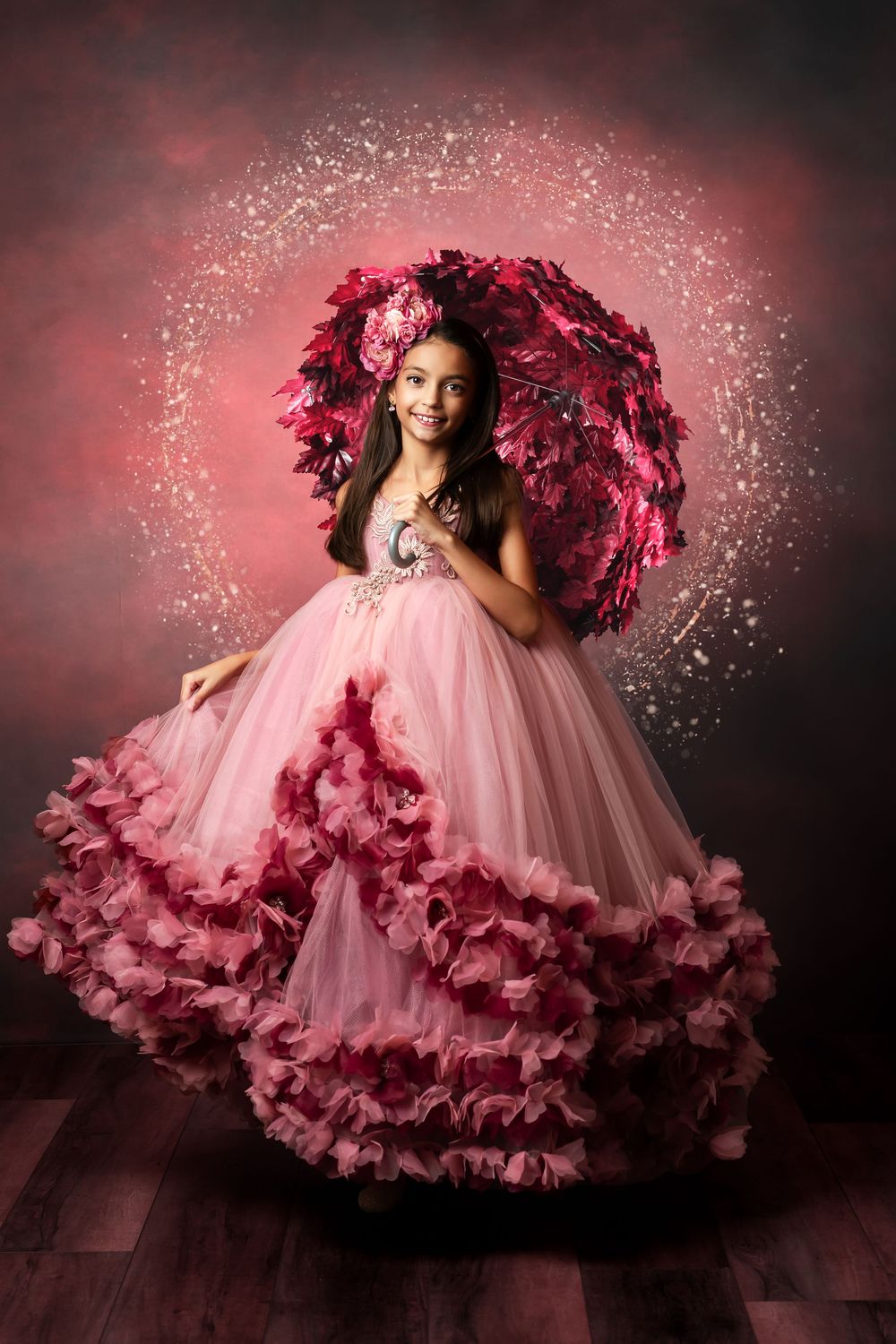 Dramatic burgundy tulle dress portraits with sparkling effects against dark background.