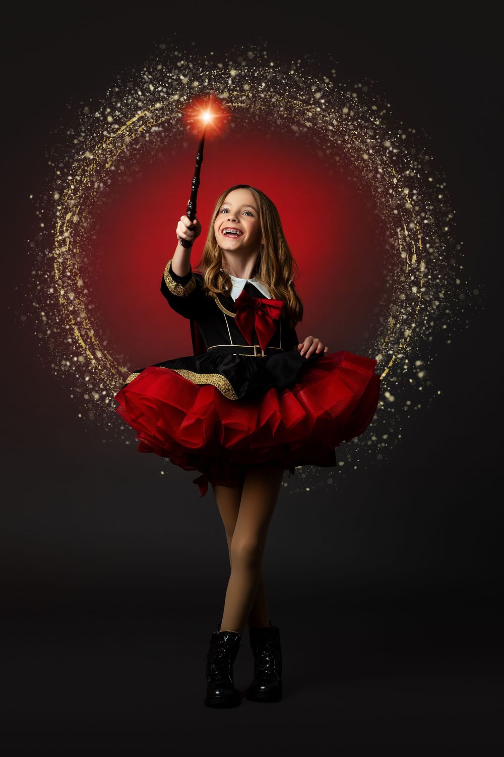 A magical portrait with sparkles and red lighting featuring someone in a black and red dress holding a wand.