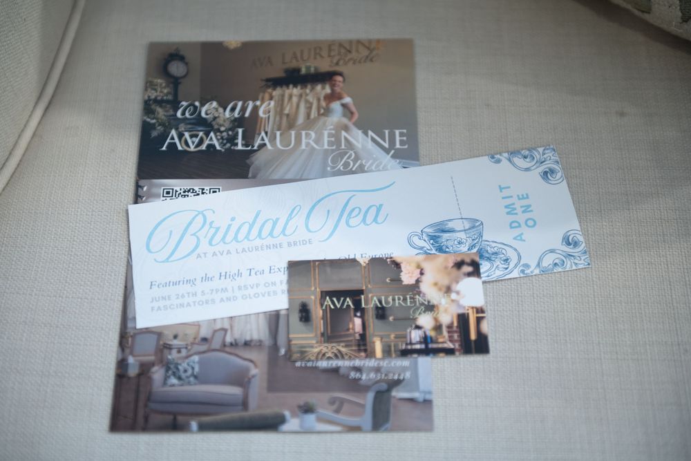 Wedding invitations and bridal spa announcements arranged on a light linen textured surface.