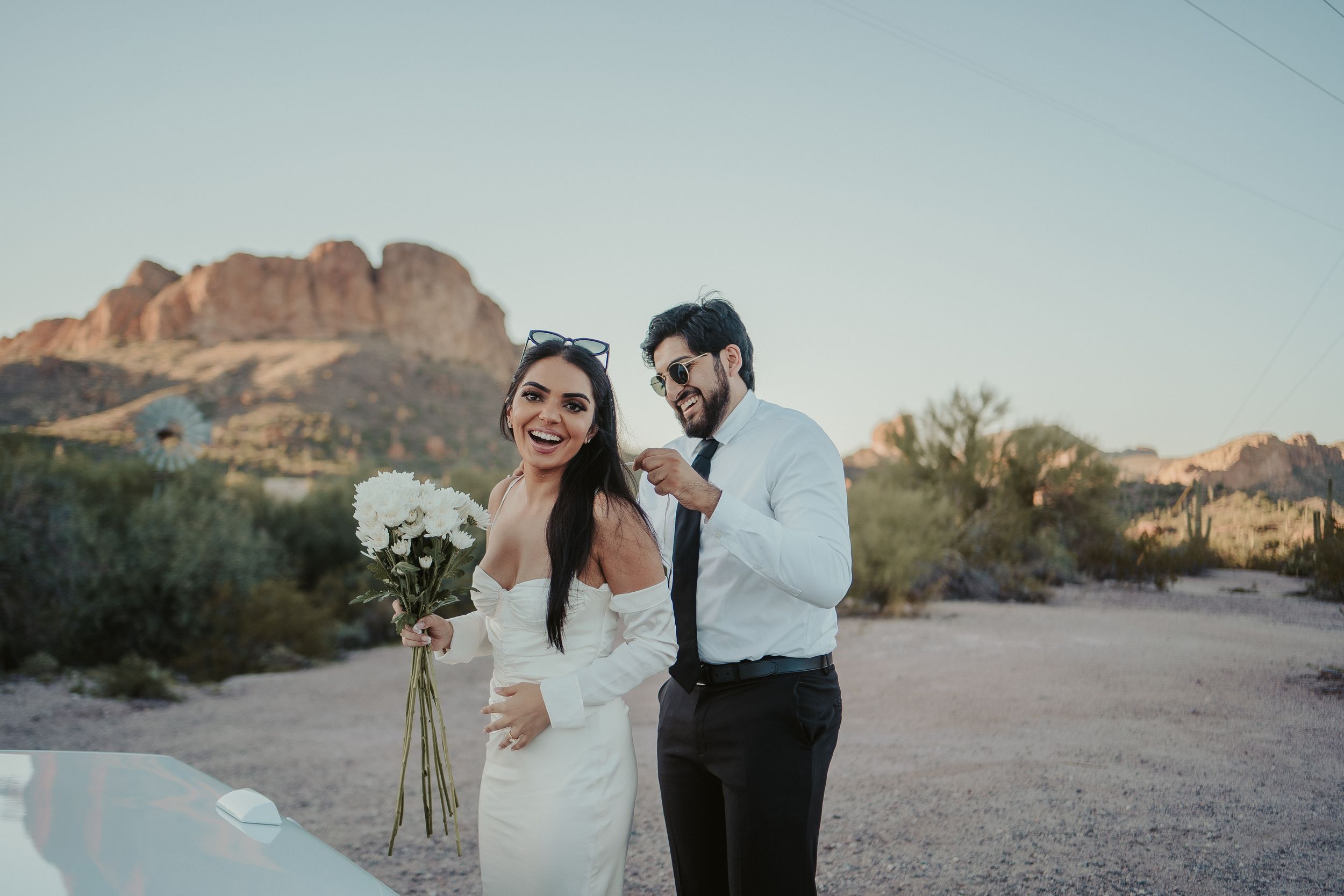 Desert wedding portrait with mountain backdrop and natural desert landscape.