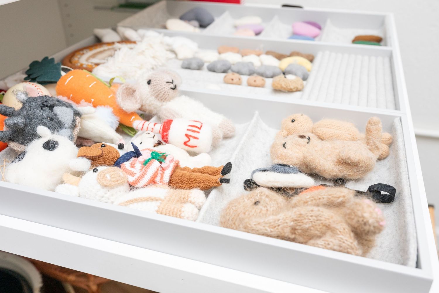 A collection of well-worn stuffed toys and plush animals displayed together on a white background.