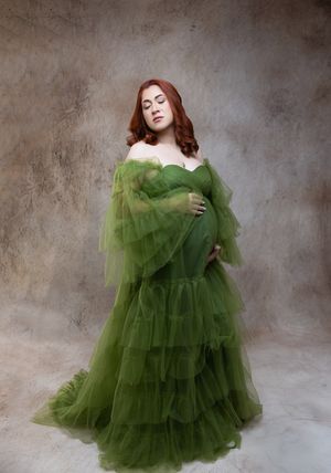 A series of romantic portraits featuring a flowing olive green tulle gown against a textured gray backdrop.