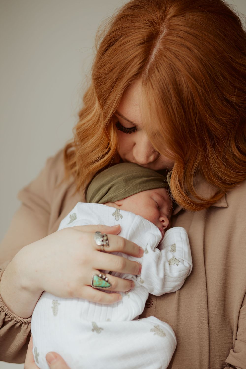 A tender moment showing gentle embrace between parent and baby in five progressive photos with soft natural lighting.
