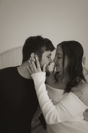 Intimate indoor portrait with dramatic lighting and contrasting outfits.