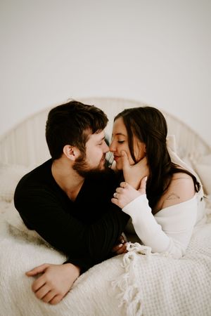 Intimate moments captured in soft monochromatic tones during couple's photoshoot.