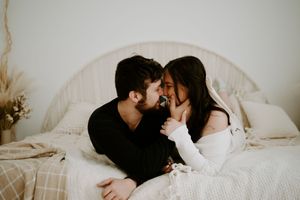 Couple's intimate photoshoot featuring soft lighting and neutral color palette.