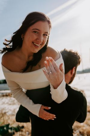 Playful couple shares intimate moments outdoors in warm sunlight.