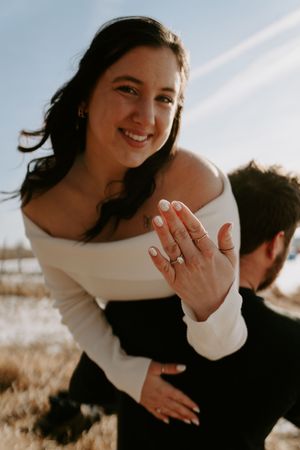 Couple shares tender moments during sunset photoshoot outdoors.