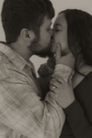 Artistic black and white portrait of couple sharing intimate moment.
