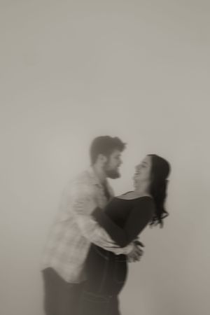 A romantic couple embraces in a dreamy black and white photo sequence showing motion and intimacy.