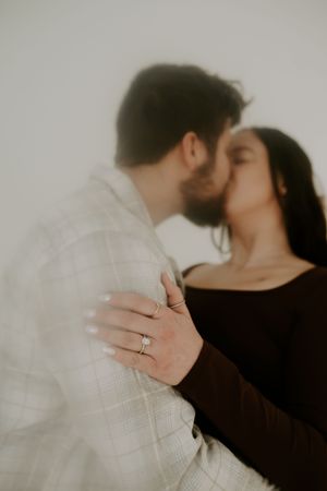 Intimate black and white portraits highlight a couple's tender moment and engagement ring.