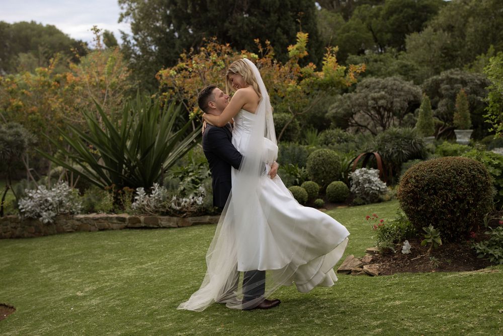 Couple shares romantic dance moments in lush garden setting captured across multiple wedding photos.