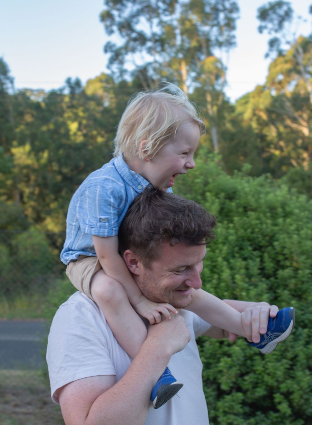 A joyful moment shared outdoors on a sunny day.