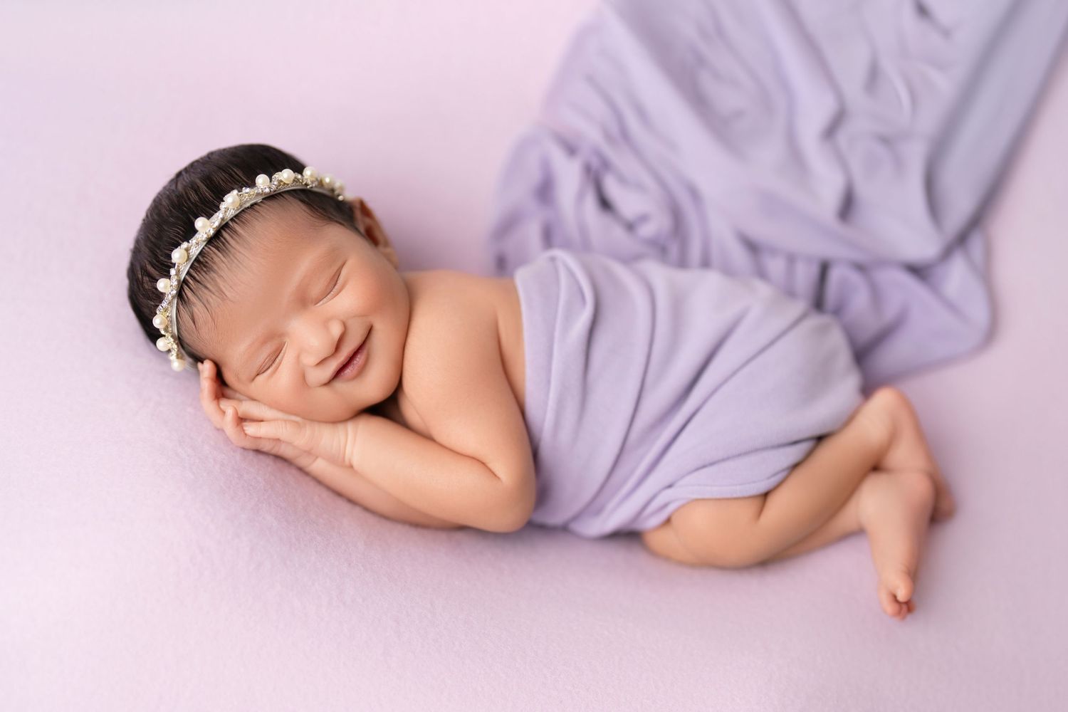 smiling newborn baby session in lavender wrap