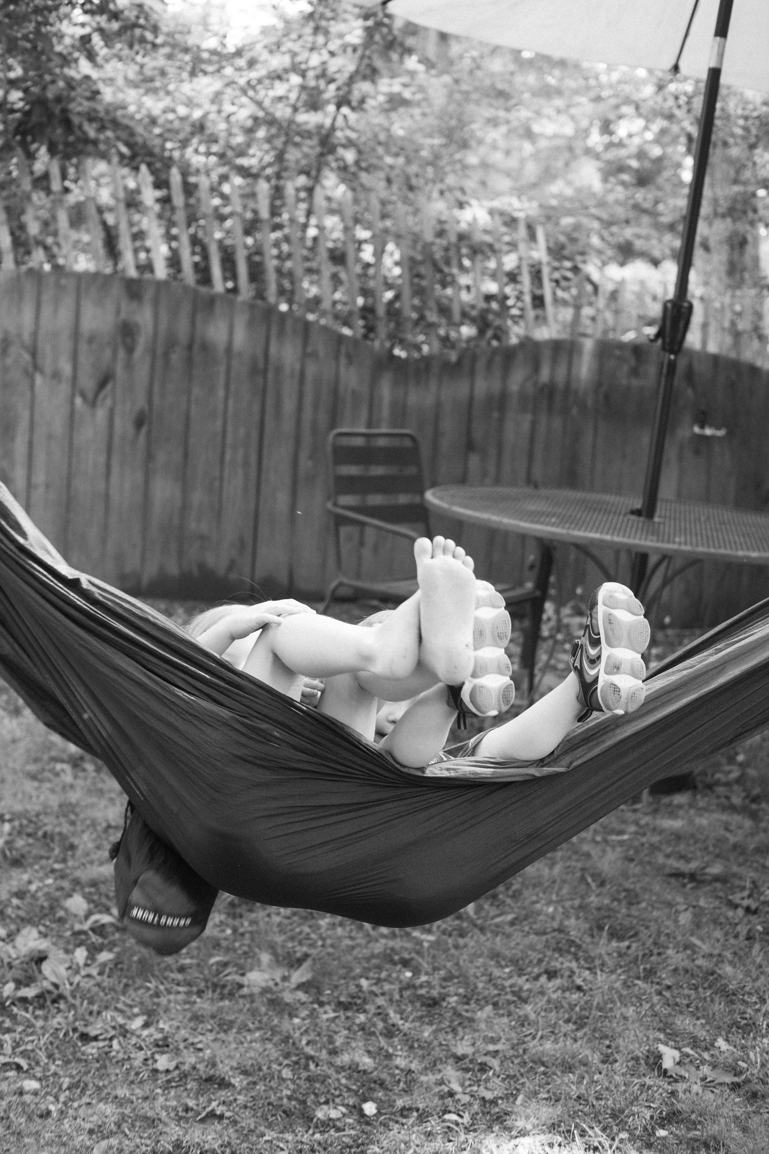 Candid film photography of children playing during a family portrait session.