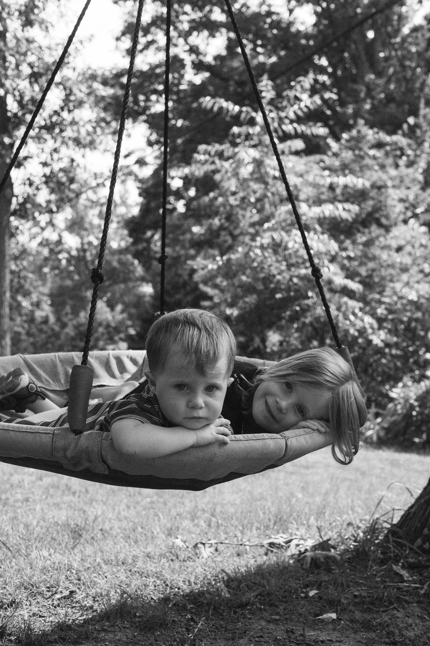 Candid film photography of children playing during a family portrait session.