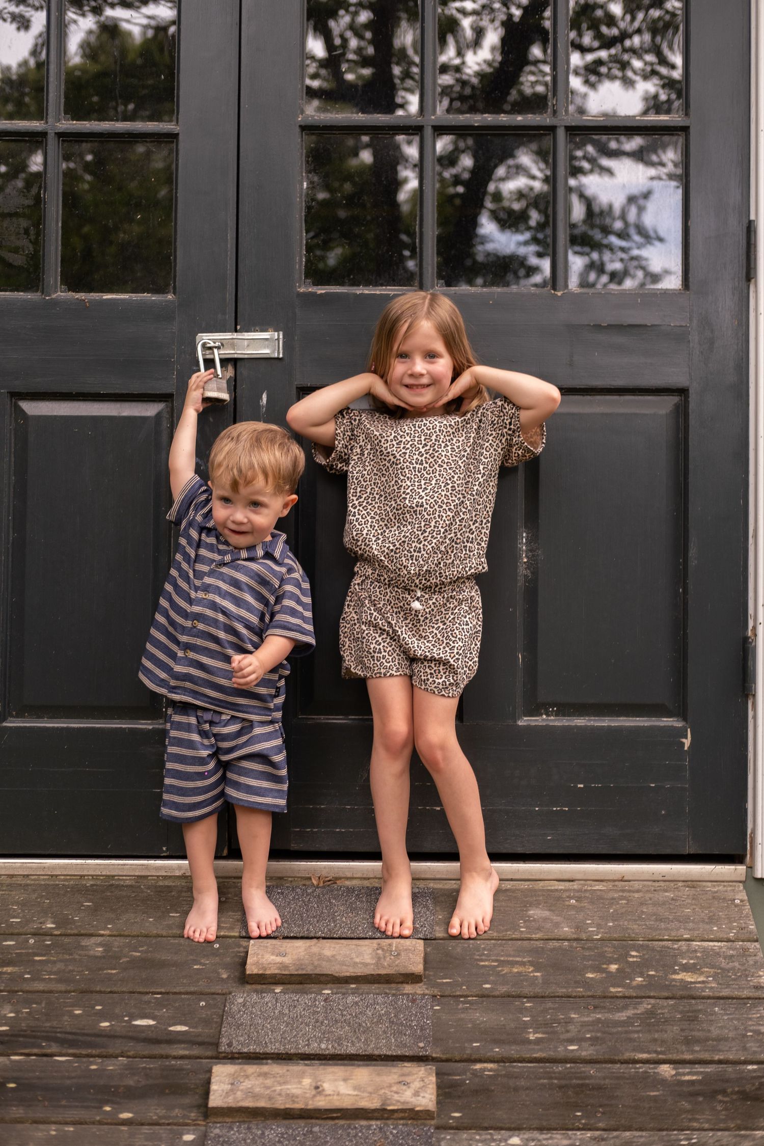 Candid film photography of children playing during a family portrait session.