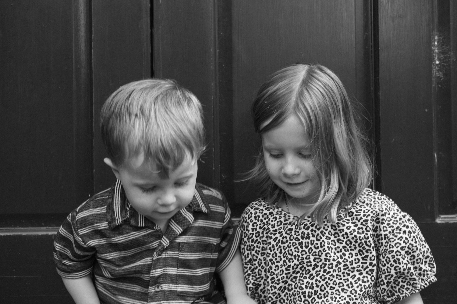 Candid film photography of children playing during a family portrait session.