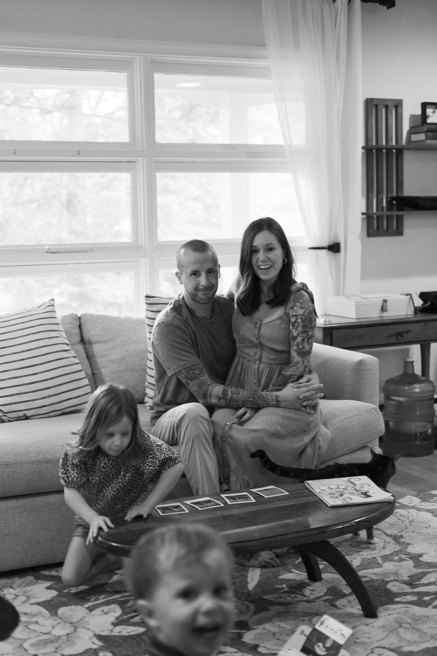Candid film photography of children playing during a family portrait session.