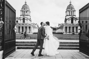 Classic black and white wedding photo at the Greenwich Royal Naval College with symmetrical domed architecture.