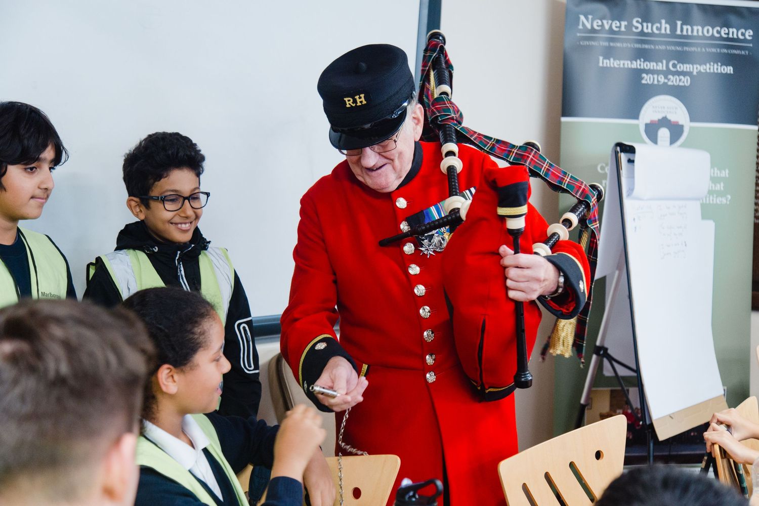 Never Such Innocence collaboration with Royal Hospital Chelsea, a Chelsea pensioner helping the school kids in the workshop.