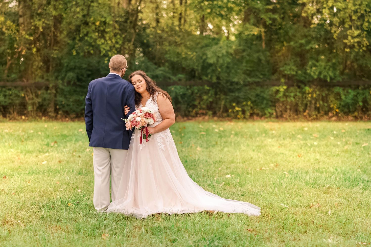 Elegant wedding photography session in a lush autumn field with golden lighting.