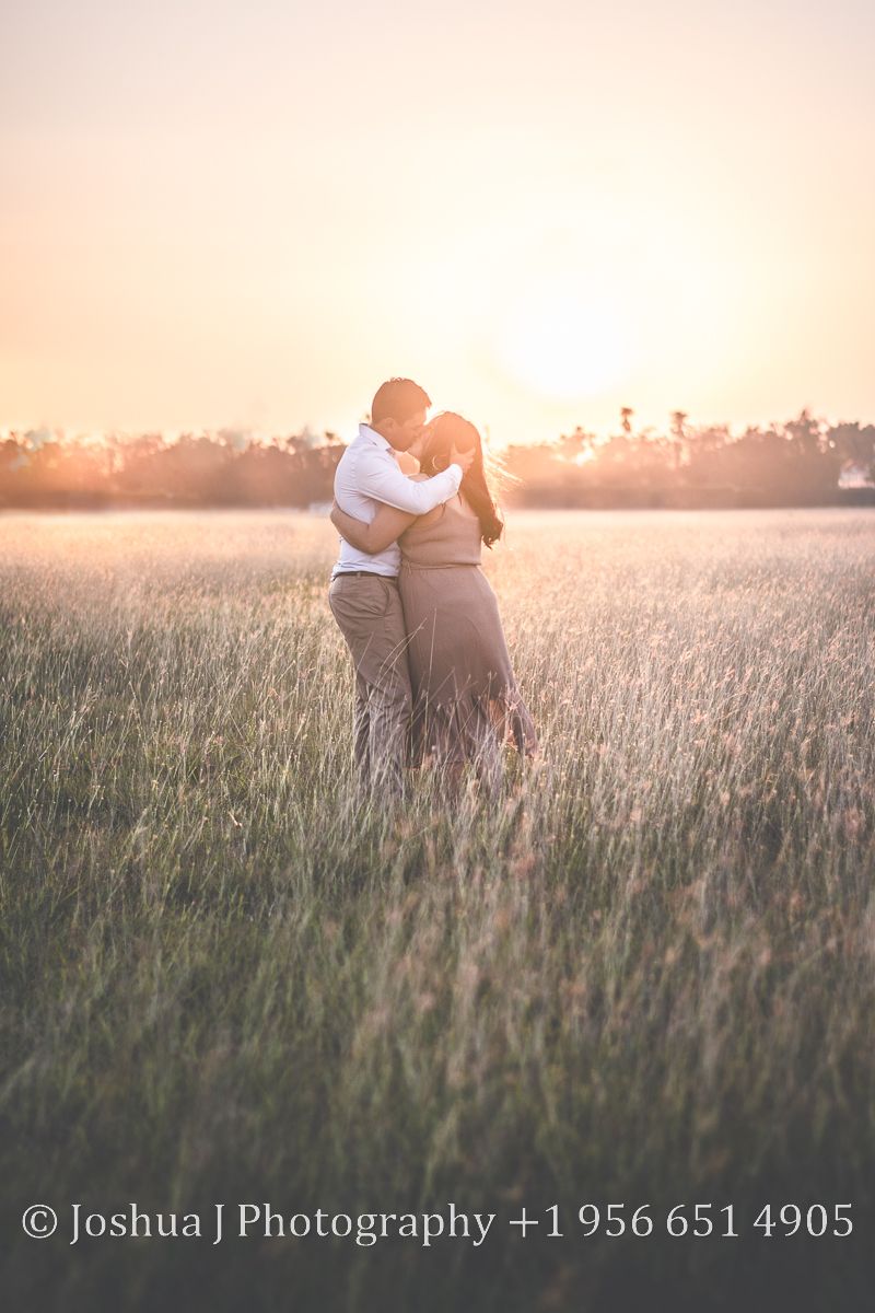 Couple kissing at sunset.