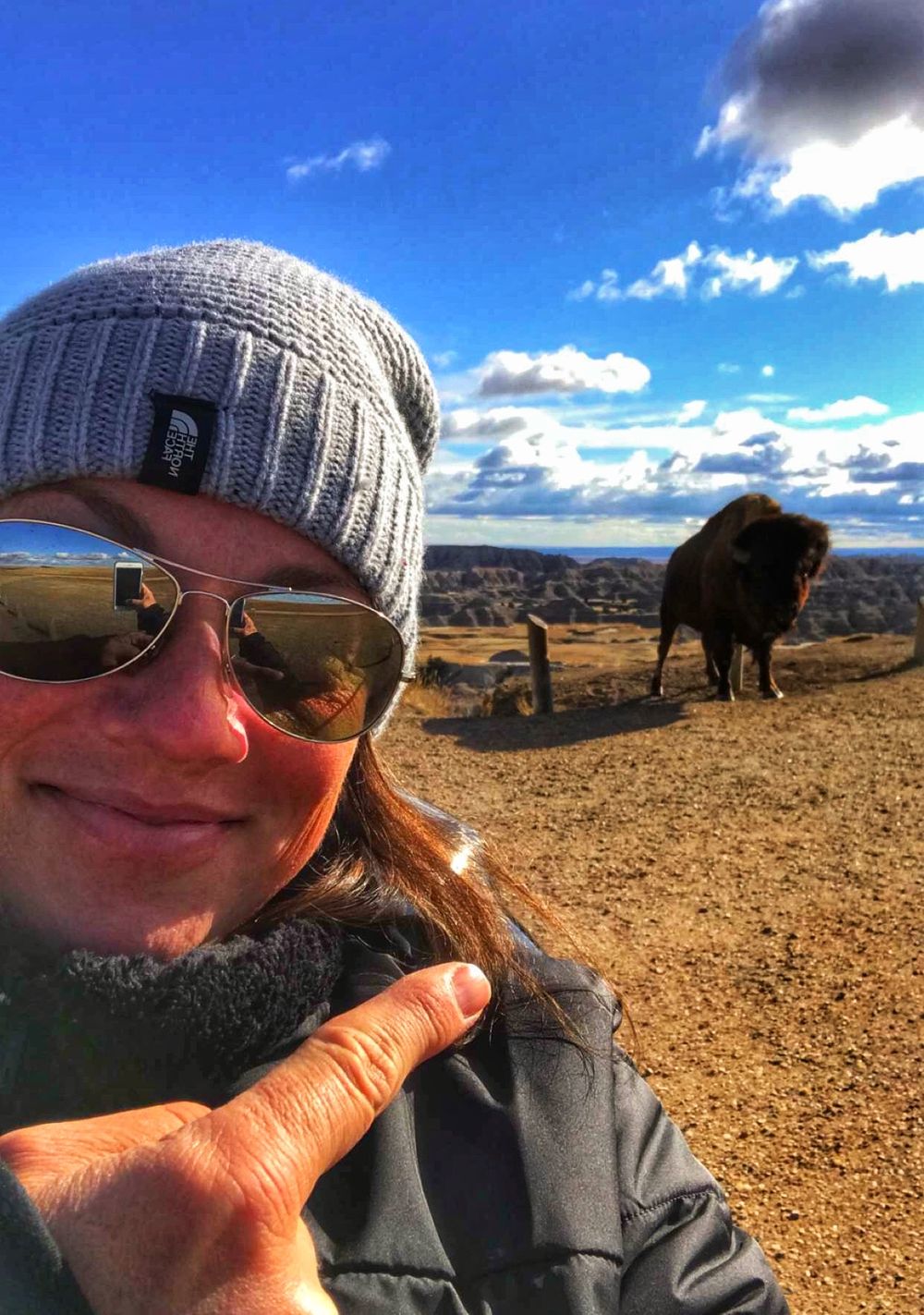 image of Sally Lombard pointing at a bison