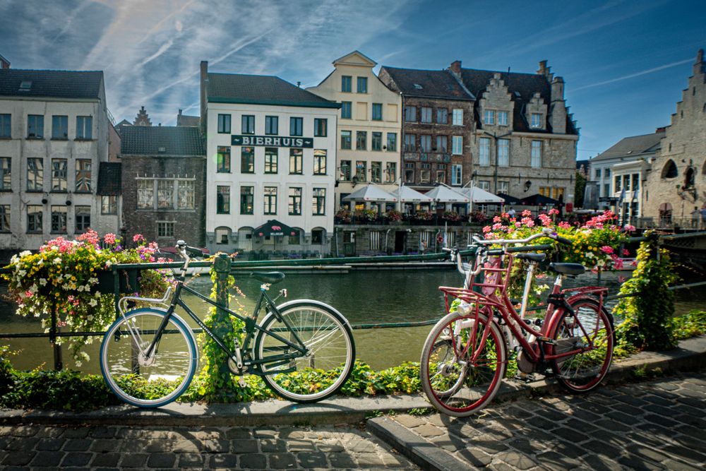 View of canal in Ghent Belgium, with bikes and flowers