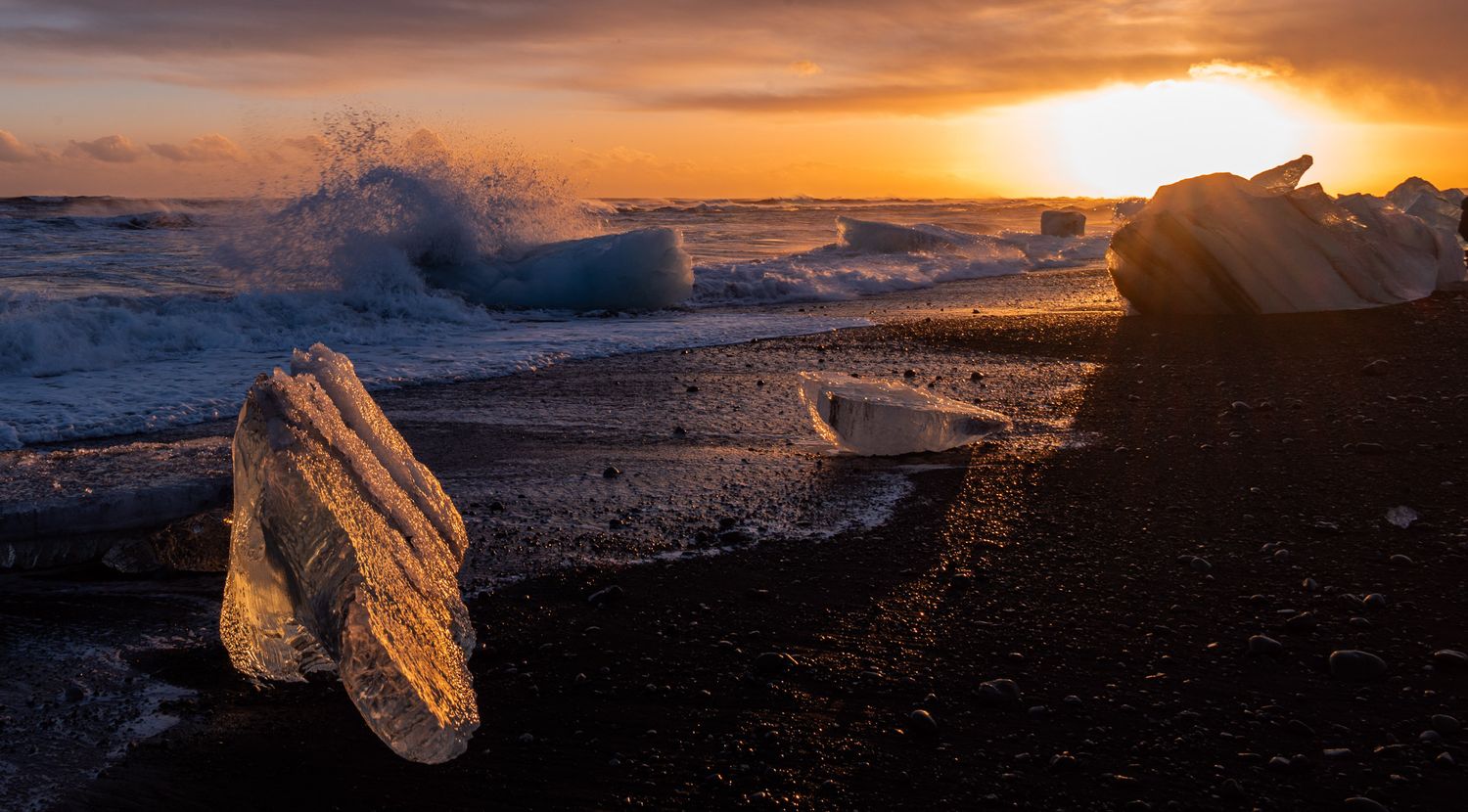 Icebergs on a black sand beach in Iceland at sunset. Image by Mark Swanson Photography.
