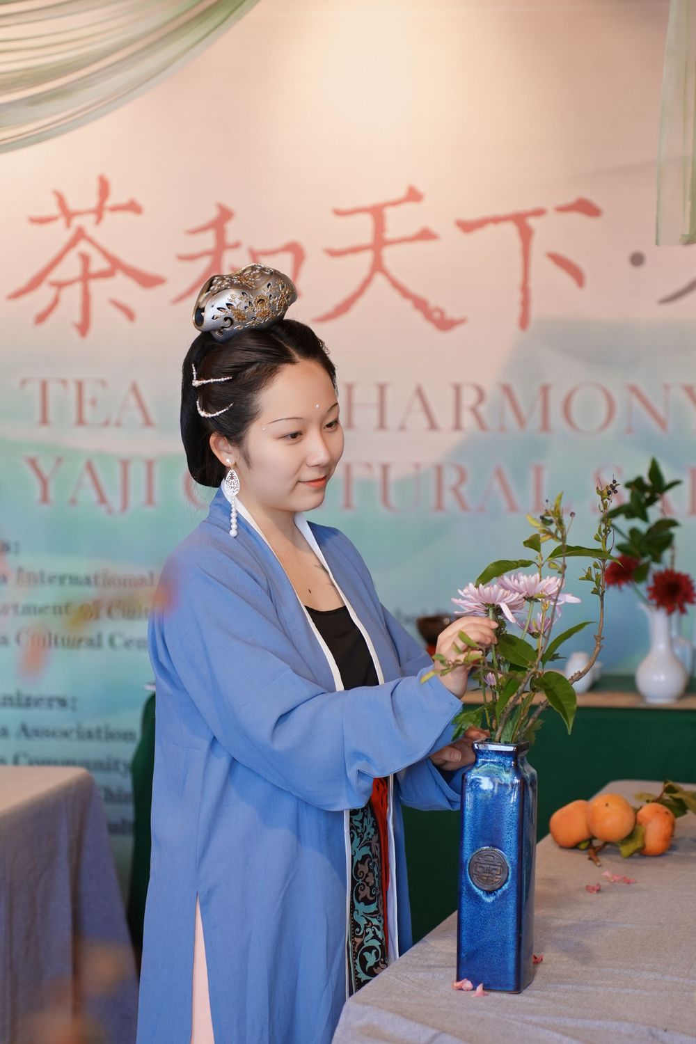 Event photography of diverse guests enjoying a traditional Chinese tea culture experience in Hanfu, by an Auckland photographer.