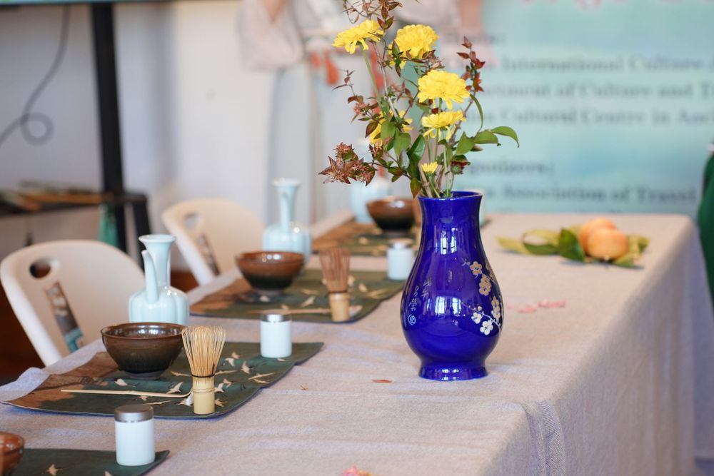 Event photography of diverse guests enjoying a traditional Chinese tea culture experience in Hanfu, by an Auckland photographer.