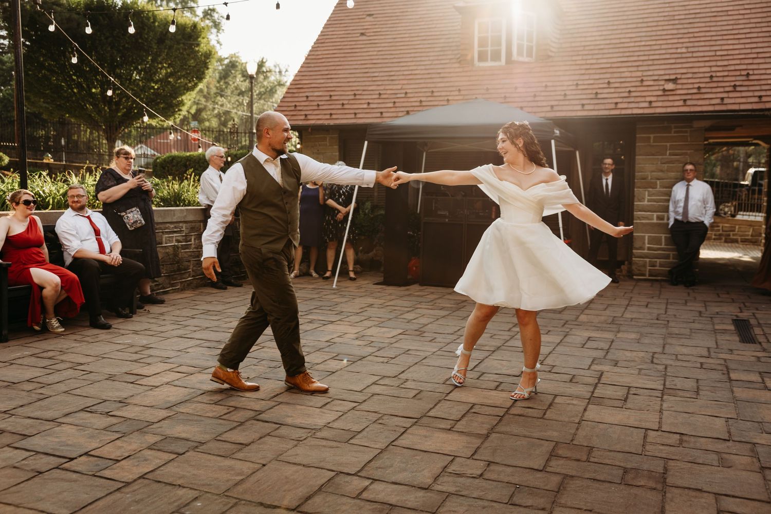 A bride and groom share a choreographed first dance out on the patio of Highgate Carriage House in Fairmont, WV.