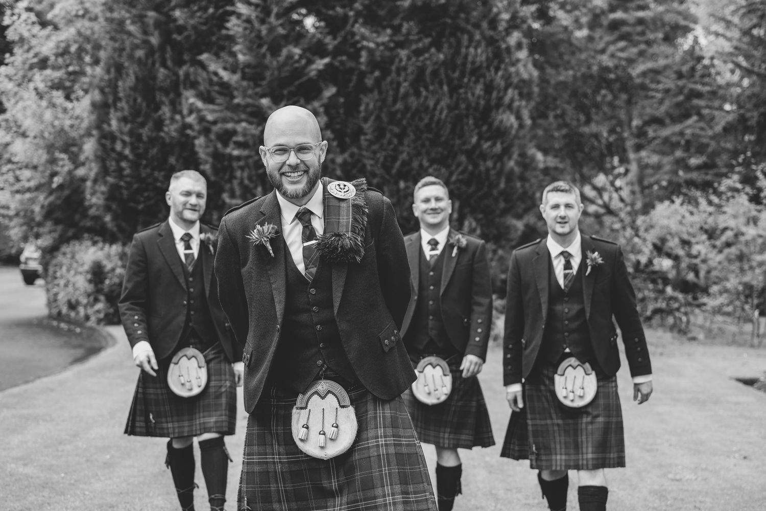 A sequence of black and white photos showing a group of men in formal attire standing outdoors.
