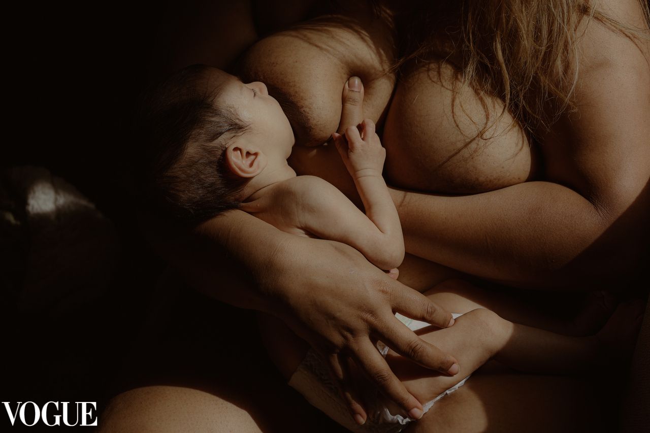 close up in colour of woman breast-feeding newborn, intimate motherhood in Suffolk,natural light