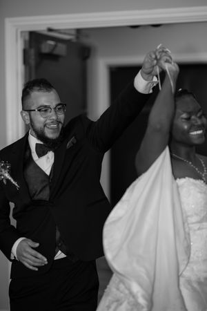 Black and white wedding photos show joyful moments between the bride in her white dress and guests at the celebration.