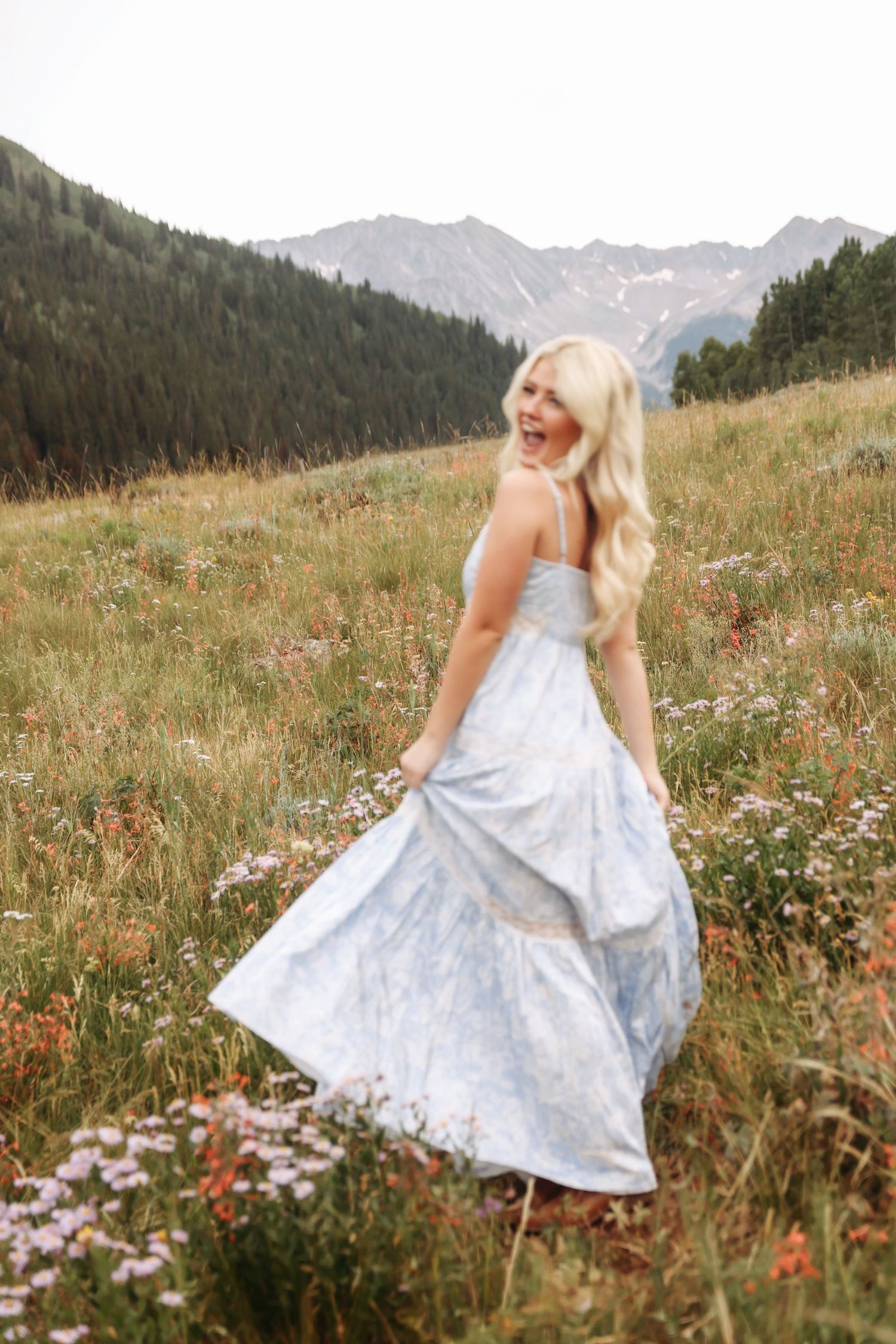 High school senior smiling in the mountains during an Aspen senior photography session