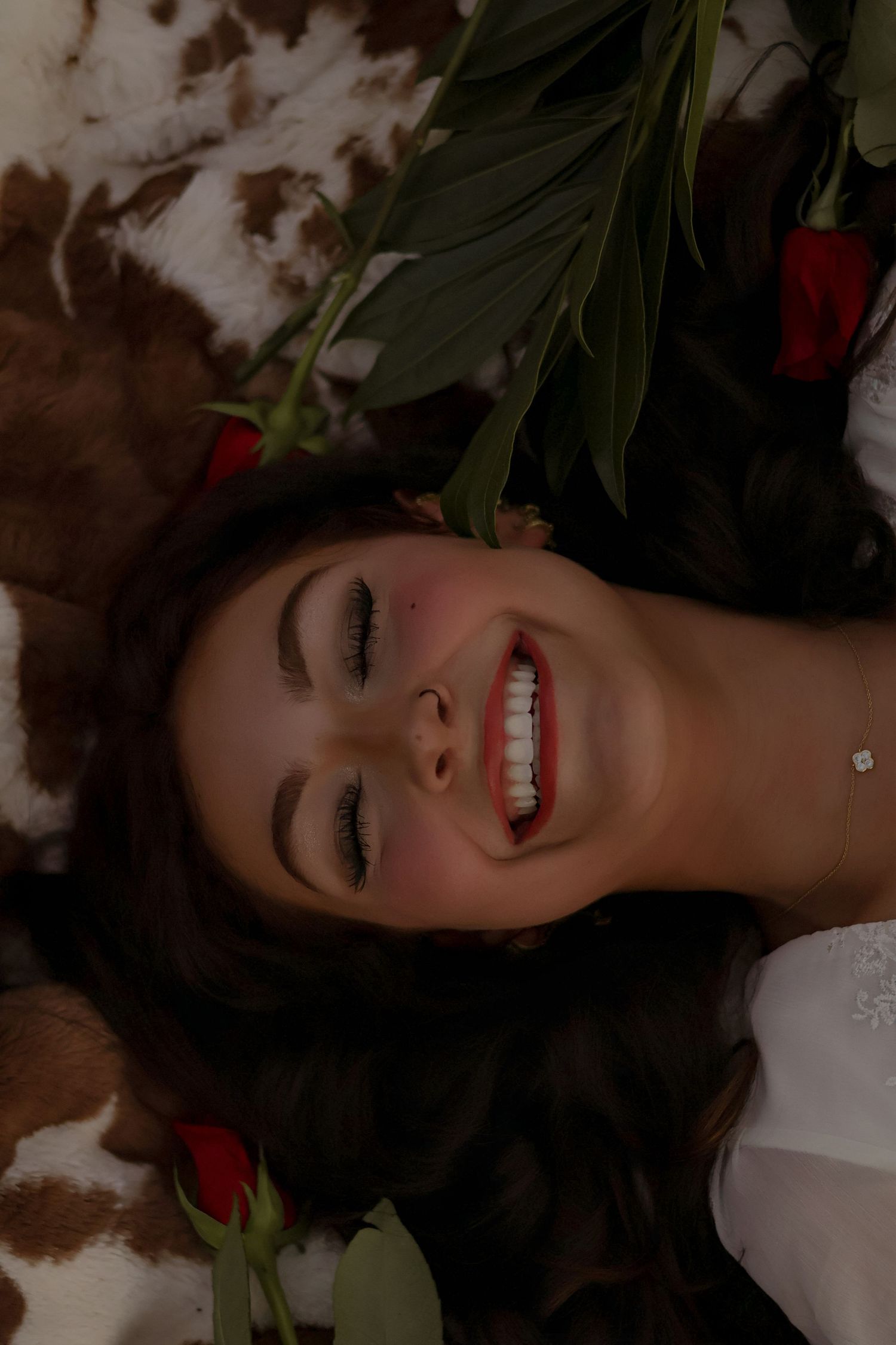 Artistic portrait series with flowers and dramatic lighting.