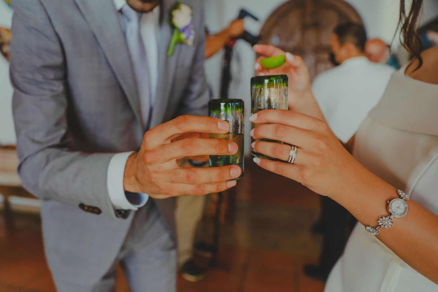 Wedding guests clink glasses in a celebratory toast during an elegant reception.Pedregal Los Cabos Wedding Photographer