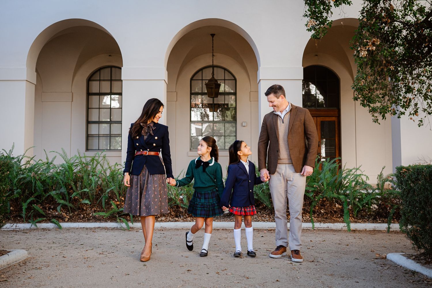 Family members walk together under white archways at Pasadena City Hall